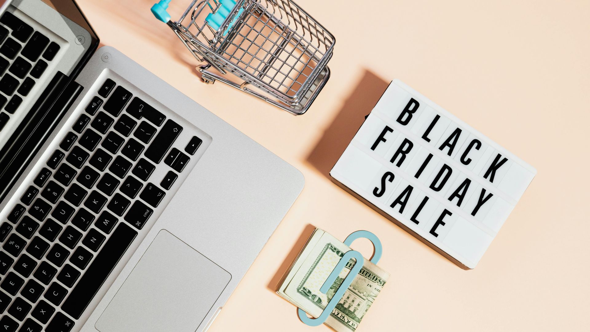 A computer and sign, stating Black Friday 2025